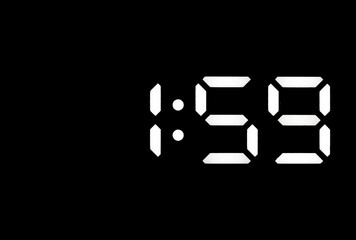 Real white led digital clock on black background