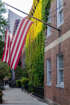 American flag on old building facade and street view in the evening. High-quality photo