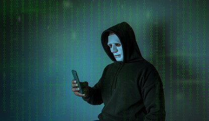 Hood hackers are using mobile to attack sensitive data in credit card background binary code. Hacking and malware concept.