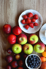 Various healthy seasonal food arranged on wooden background. Flat lay.