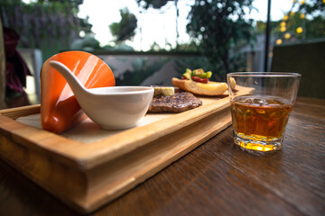 whiskey and steak with sauce on wood.
