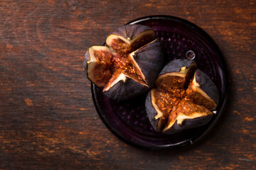 Two juicy figs on a plate