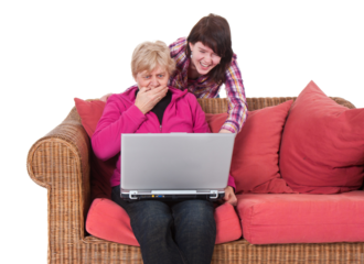 Granddaughter shows her grandma something amazing at her compute