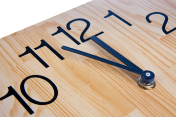 Wooden clock saying five to twelve