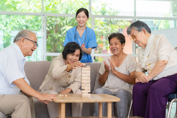 Dementia therapy in playful way. Group of senior elder people stay at nursing home, enjoy...