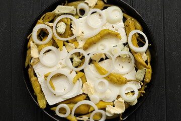 Baked feta cheese with pepperoni and onions