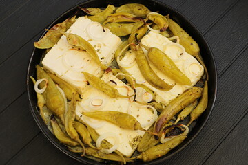 Baked feta cheese with pepperoni and onions