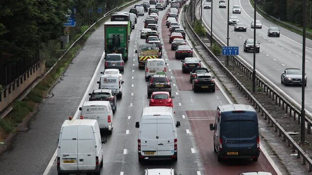 Heavy, slow moving morning rush hour traffic on a busy main road.