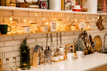 Kitchen interior decorated with Christmas garlands and Christmas trees