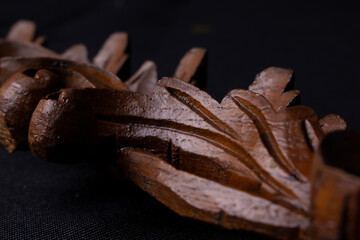 close up detail shot of wood carving traditional art with floral theme on isolated black background illustration ideas
