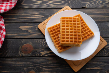 waffles with berries, strawberries and honey on wooden table