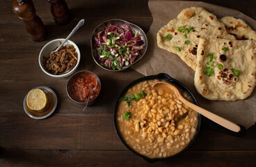Stewed beans and flat breads served along pickled onion, sauteed onions and salsa