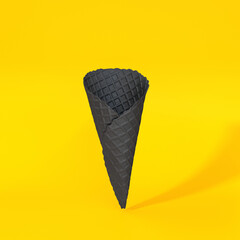 Black waffle cone floating on a yellow background, 3d render