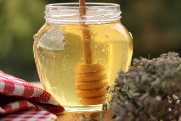 jar of honey with dipper
