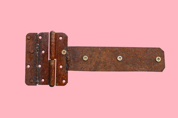 rusty metal door hinge. Door hinge isolated on pink background