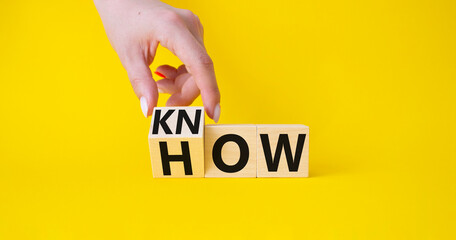 Know how symbol. Businessman hand turnes wooden cubes and changes word How to Know. Beautiful...