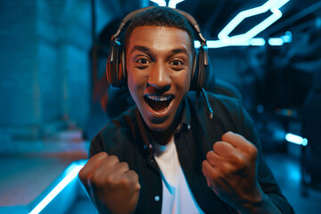 Lucky guy won the game. A cyber gamer is playing in a neon room. © callisto