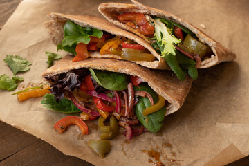 Pita bread pockets filled with  roasted bell peppers and greens