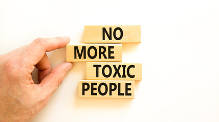 No more toxic people symbol. Concept words No more toxic people on wooden blocks on a beautiful white table white background. Psychologist hand. Business, psychological no more toxic people concept.
