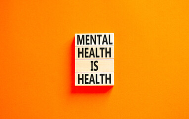 Mental health psychological symbol. Concept words Mental health is health on wooden blocks on a beautiful orange table orange background. Psychological mental health concept.