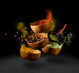 Zelfklevend Fotobehang Spices and seasonings powder splash, explosion on black background © Soho A studio