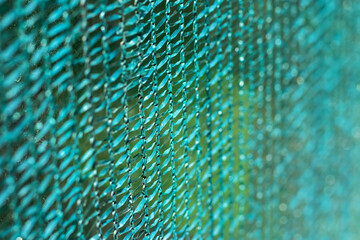 Knitted polyethylene mesh background, sun protection material that creates shade danger of solar overheating concept