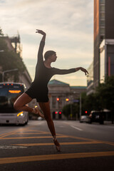 Fototapeta na wymiar Girl Dancing in City During Sunset