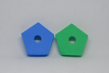 blue and green pentagon toys on white