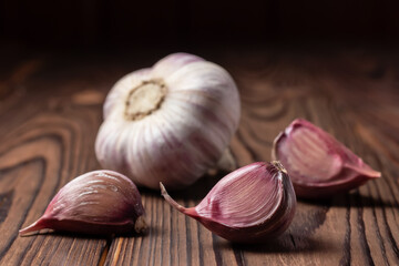 Garlic cloves on wooden table. Fresh peeled garlics and bulbs.