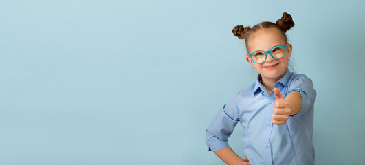 Happy girl with Down syndrome having fun and laughing in the studio. Banner. Copy space