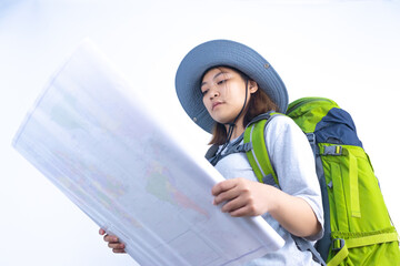 Asian woman traveling with backpack and bucket hat ready to travel with map in white studio