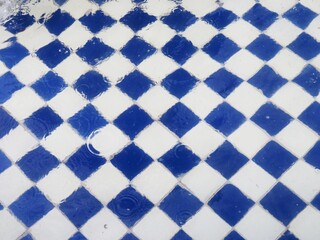 blue and white tiles in a fountain full of water