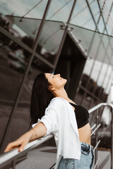 portrait woman fashioin in street outdoors. Jeans, white shirt