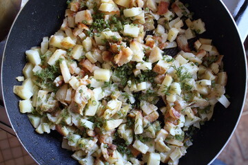 fried potatoes with dill in a pan