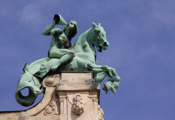 Fototapeta na wymiar Women's equestrian statue with curtain, building decoration