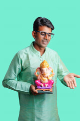 Young Indian man with Lord Ganesha , Celebrating Ganesha festival