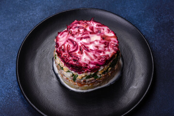 Traditional Ukrainian multilayered salad from herring, beets, potatoes, carrots and eggs