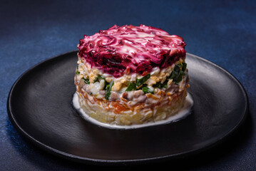 Traditional Ukrainian multilayered salad from herring, beets, potatoes, carrots and eggs