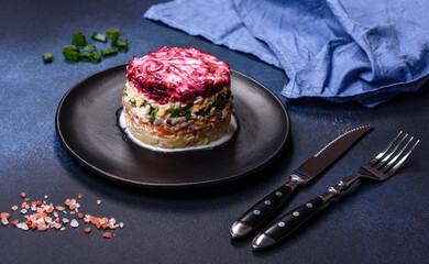 Traditional Ukrainian multilayered salad from herring, beets, potatoes, carrots and eggs