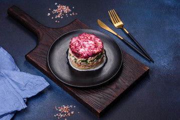 Traditional Ukrainian multilayered salad from herring, beets, potatoes, carrots and eggs