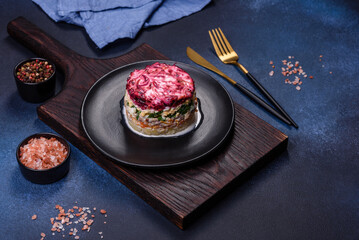 Traditional Ukrainian multilayered salad from herring, beets, potatoes, carrots and eggs