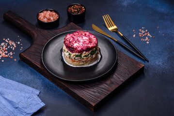 Traditional Ukrainian multilayered salad from herring, beets, potatoes, carrots and eggs