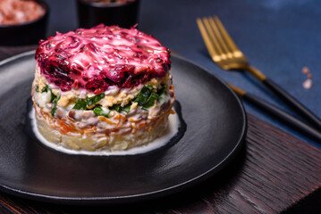 Traditional Ukrainian multilayered salad from herring, beets, potatoes, carrots and eggs