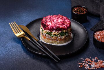 Traditional Ukrainian multilayered salad from herring, beets, potatoes, carrots and eggs