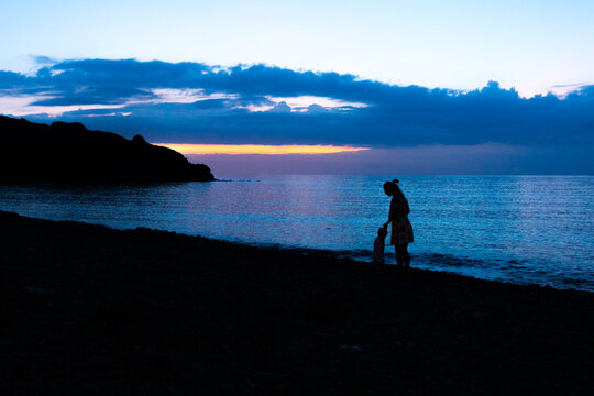 Mother and child on the beach, enjoing sunrise together!Eftalou in Molyvos, Lesvos of Greece.
