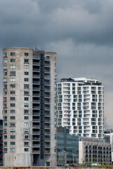 Fototapeta na wymiar Modern apartment buildings, Dark skies above - Stock Photo