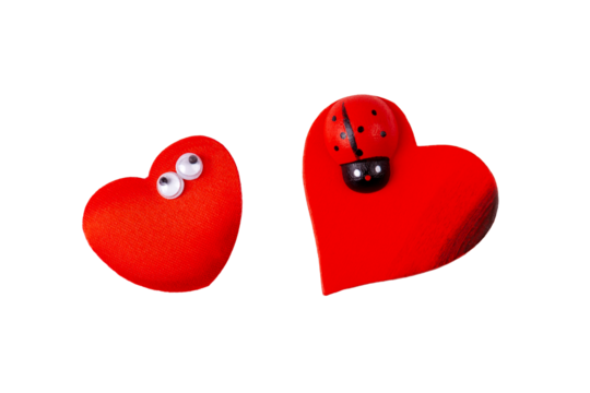 Two little funny quirky red hearts, heart pair, objects isolated on white background, cut out, nobody. Valentines day, love symbol concept, design element. Heart with eyes and heart with a ladybug