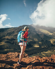Hiker woman standing on slopes of Mt. Etna
