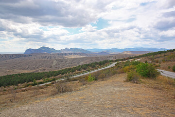 Mountain landscape on an autumn day, long road