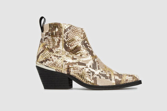 Beige women's fashion cossack Cowboy boot in python snake skin leather isolated on white background. Female classic spring autumn shoe with Pointy Toe, heel. Casual footwear in animal print. Template